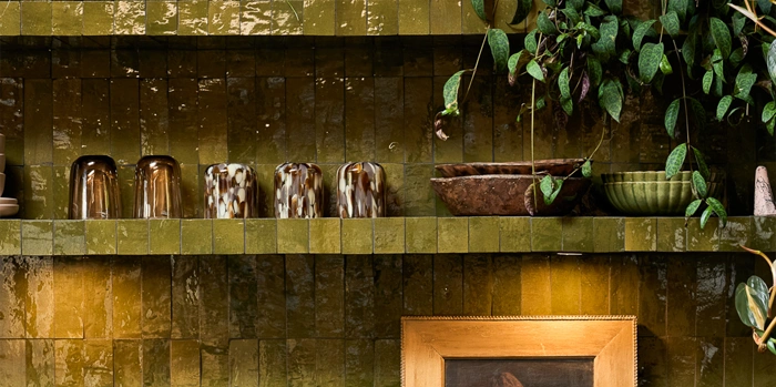 Green zellige tiles on wall and console